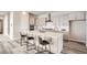 Modern kitchen with island seating, stainless appliances, sleek countertops and gray wood flooring at 959 Promenade Dr, Superior, CO 80027