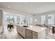 Open kitchen with stone countertops, stainless appliances, and island with seating, leads to the living room at 959 Promenade Dr, Superior, CO 80027