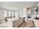 Modern kitchen with island seating, stainless appliances, sleek countertops, and open dining area at 959 Promenade Dr, Superior, CO 80027