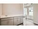 A laundry area with cabinetry and sink, with durable flooring and a view into the next room at 959 Promenade Dr, Superior, CO 80027