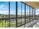 Bright sunroom featuring expansive glass windows offering panoramic views of the surrounding landscape at 14152 E Linvale Pl # 605, Aurora, CO 80014