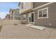 Back of home features a stone patio, sliding glass doors, and neutral siding at 4574 Walden St, Denver, CO 80249
