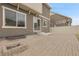 Home's backyard has stone patio and neutral siding at 4574 Walden St, Denver, CO 80249