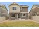 Back of home has grass and a stone patio at 4574 Walden St, Denver, CO 80249