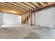Spacious unfinished basement featuring concrete floor, a stud frame and exposed ceiling with utilities at 4574 Walden St, Denver, CO 80249