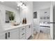 Well-lit bathroom featuring double vanity and a view of the en suite bedroom at 4574 Walden St, Denver, CO 80249