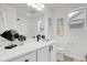 Bright bathroom with white cabinets, black hardware, stylish mirror, vanity, and decor with a window at 4574 Walden St, Denver, CO 80249