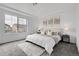 Bright bedroom with a large window, plush carpet, and a comfortable queen-size bed with elegant artwork at 4574 Walden St, Denver, CO 80249