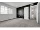 Empty bedroom featuring a bold accent wall, a double-hung window, and access to hallway and closet at 4574 Walden St, Denver, CO 80249