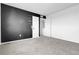 Spacious bedroom features modern black accent wall and neutral carpeting at 4574 Walden St, Denver, CO 80249