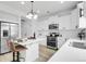 Kitchen features stainless steel appliances, ample counter space, and an island with seating for casual dining at 4574 Walden St, Denver, CO 80249
