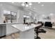 Open-concept kitchen with an island featuring barstool seating and modern lighting fixtures at 4574 Walden St, Denver, CO 80249