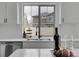 A bright and modern kitchen sink with a view of the outside, complete with wine glasses and decoration at 4574 Walden St, Denver, CO 80249