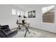 Modern office space featuring a stylish desk, comfortable seating, and ample natural light from multiple windows at 4574 Walden St, Denver, CO 80249