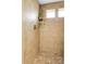 The walk-in shower features decorative brown tile and a glass shelf at 4574 Walden St, Denver, CO 80249