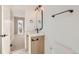 Stylish bathroom with light wood vanity, quartz countertop, and black accents at 3916 N Mariposa St, Denver, CO 80211