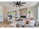 Living area with brick fireplace, hardwood floors, and a ceiling fan at 3916 N Mariposa St, Denver, CO 80211