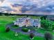 Modern home on an estate lot with a lush green lawn and mature trees at 7330 Centennial Dr, Parker, CO 80138