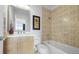 Full bathroom with tile shower and floors, plus a light wood vanity with a sink at 7330 Centennial Dr, Parker, CO 80138