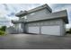 Contemporary home with a sleek gray exterior, balcony, and a two-car garage at 7330 Centennial Dr, Parker, CO 80138