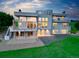 Back exterior with a full view of the house, beautiful balcony, patio and lush green lawn at 7330 Centennial Dr, Parker, CO 80138