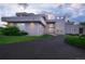 Contemporary house showcasing a landscaped yard, modern lighting, and a sleek driveway design at 7330 Centennial Dr, Parker, CO 80138
