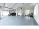 Spacious, well-lit garage with epoxy flooring and ample storage space at 7330 Centennial Dr, Parker, CO 80138
