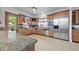 Well-equipped kitchen with custom wood cabinets, stainless steel appliances, and granite countertops at 7330 Centennial Dr, Parker, CO 80138