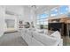 Spacious living room with a fireplace, built-in shelving, and scenic outdoor views from large windows at 7330 Centennial Dr, Parker, CO 80138