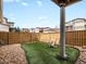 Low maintenance backyard with artificial turf, gravel landscaping, and a stylish Adirondack chair at 3368 Cranston Cir, Highlands Ranch, CO 80126
