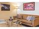 Close-up of finished basement with sofa, glass tables and wall art creating a comfortable atmosphere at 3368 Cranston Cir, Highlands Ranch, CO 80126