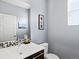 Modern half bathroom with stylish mosaic backsplash, floating vanity, and framed wall art at 3368 Cranston Cir, Highlands Ranch, CO 80126