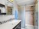 Contemporary bathroom featuring a sleek vanity, a glass-enclosed shower with tiled walls, and modern fixtures at 3368 Cranston Cir, Highlands Ranch, CO 80126