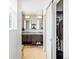 Modern bathroom with double vanity, decorative mirrors, and tiled floors at 3368 Cranston Cir, Highlands Ranch, CO 80126