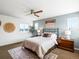 Bright bedroom featuring a comfortable bed, artwork, and abundant natural light through the windows at 3368 Cranston Cir, Highlands Ranch, CO 80126