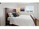 Bedroom with wood furniture, a decorative pillow arrangement, and natural light at 3368 Cranston Cir, Highlands Ranch, CO 80126