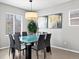 Dining room featuring a glass table with seating for eight, a modern chandelier, and neutral decor at 3368 Cranston Cir, Highlands Ranch, CO 80126
