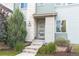 Inviting entrance featuring a modern door with glass panels and well-kept landscaping at 3368 Cranston Cir, Highlands Ranch, CO 80126