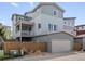 Stylish home showcasing a two-car garage, spacious balcony, and modern architectural design at 3368 Cranston Cir, Highlands Ranch, CO 80126