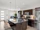 Well appointed kitchen with stainless appliances, granite counters, an island with bar seating and modern cabinetry at 3368 Cranston Cir, Highlands Ranch, CO 80126