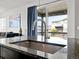 Close-up of kitchen island sink with granite countertop and stylish faucet, with views of the deck at 3368 Cranston Cir, Highlands Ranch, CO 80126