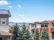 Scenic view of neighborhood houses with mountain views in the background and evergreen trees at 3368 Cranston Cir, Highlands Ranch, CO 80126