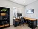 Well-lit office space featuring a built-in desk, shelving, and a large window for natural light at 3368 Cranston Cir, Highlands Ranch, CO 80126