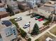 Overhead view of a parking lot with several parked cars near modern townhomes and lush landscaping at 3368 Cranston Cir, Highlands Ranch, CO 80126
