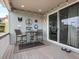 Cozy patio features decorative wall art, string lights, a table, and access to the interior at 3368 Cranston Cir, Highlands Ranch, CO 80126
