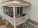 Cozy covered porch area features comfortable seating, a grill, and sliding glass doors, creating an ideal outdoor living space at 3368 Cranston Cir, Highlands Ranch, CO 80126