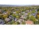 An aerial view of the neighborhood, showing houses, trees, and the city skyline in the distance at 824 E Iowa Ave, Denver, CO 80210