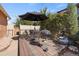 Back deck features a table with umbrella, chairs, and a grill, perfect for outdoor dining and entertaining at 824 E Iowa Ave, Denver, CO 80210