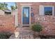 Close-up of the front door entrance with brick steps, flower, and house number; showcasing the inviting entryway at 824 E Iowa Ave, Denver, CO 80210