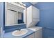 Bathroom with light blue vanity, stacked washer/dryer, and mirror at 740 N Pearl St # 203, Denver, CO 80203